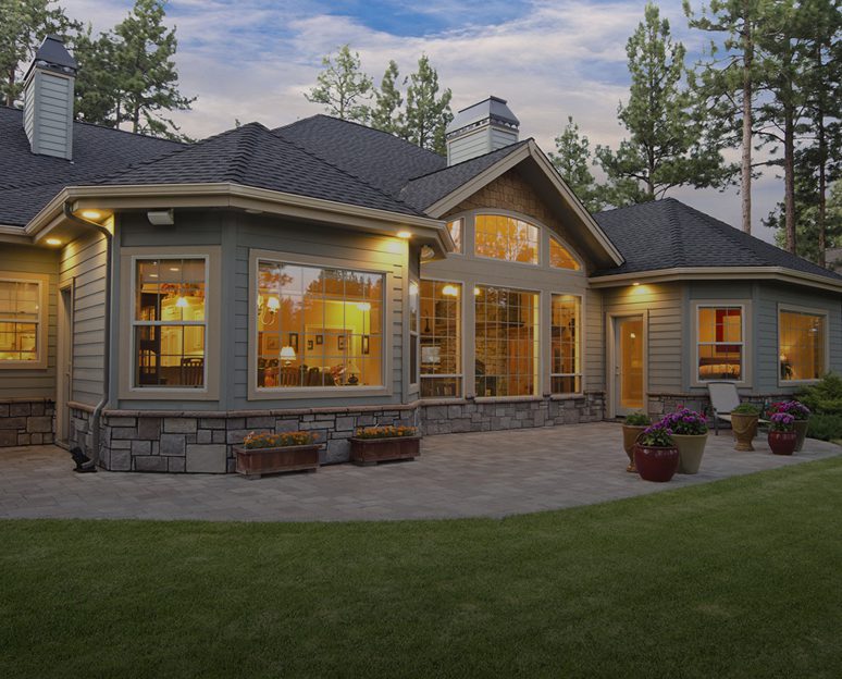 Beautiful house with large windows and patio.